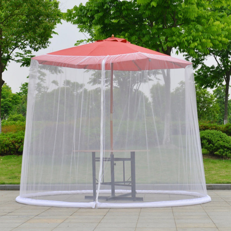 Mosquito net screen hanging from a patio umbrella to the ground