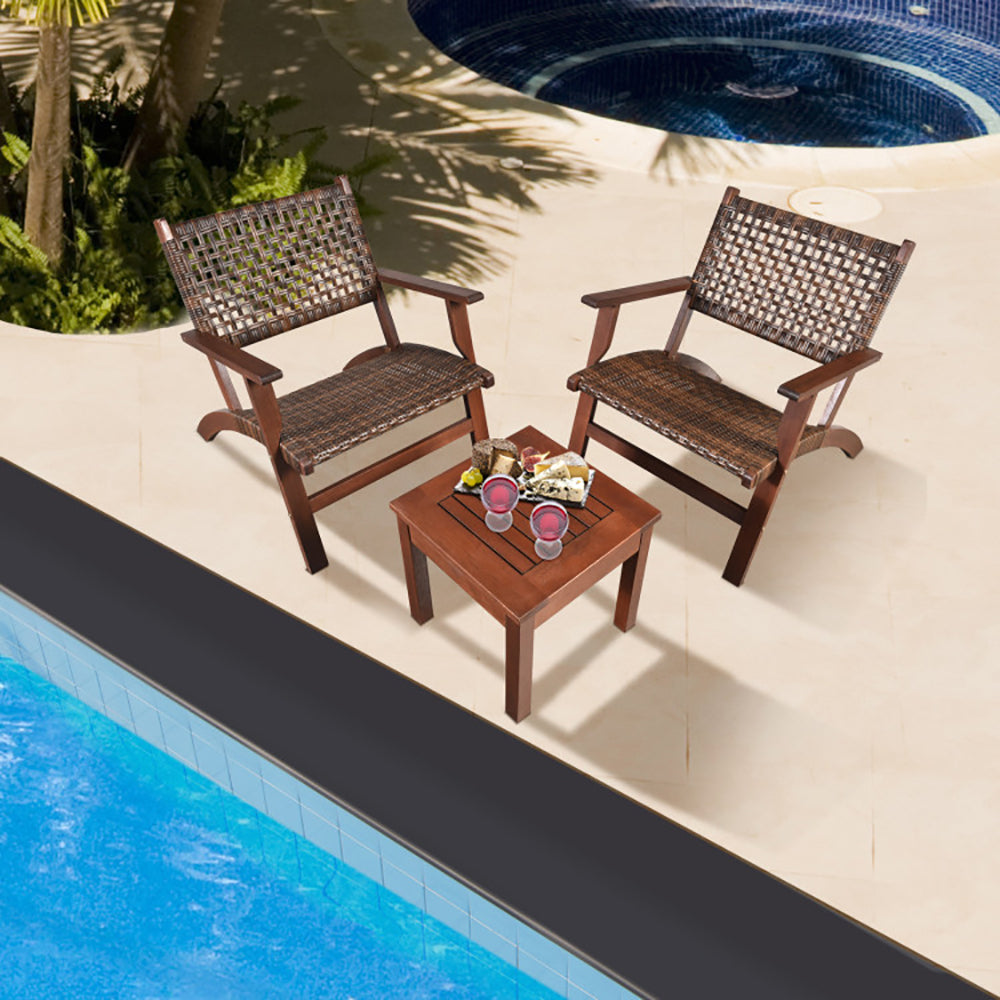 Three-piece wood and rattan patio set with two chairs and a side table
